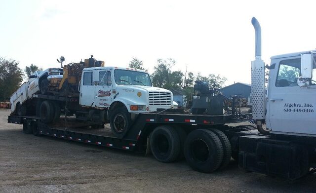 A customer's service truck, boring rig and all, riding our Trailking beavertail trailer in one piece