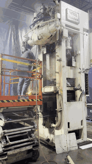 Video: the cutting torch working through the press frame, sparks running down the column
