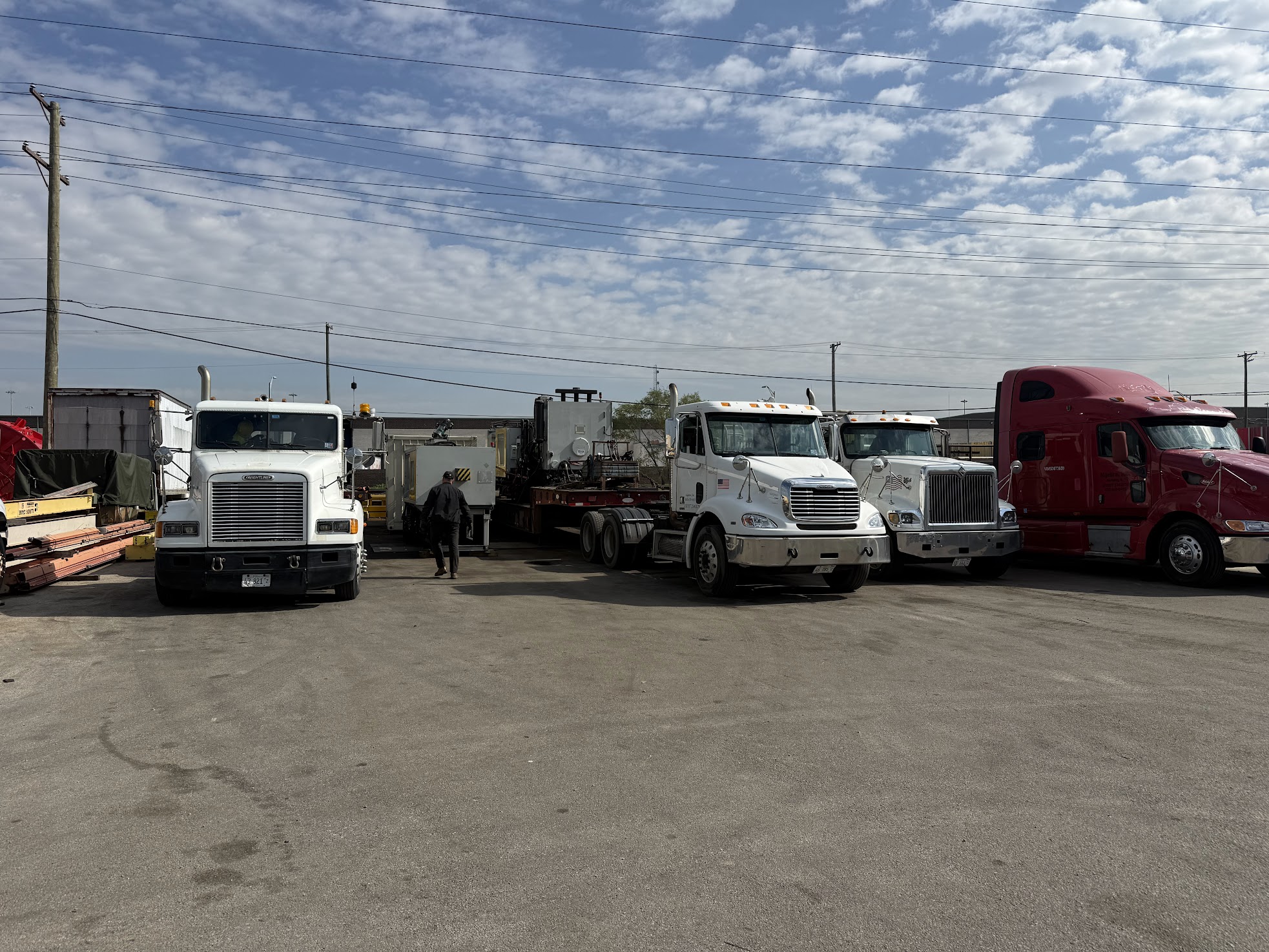 Four of our own semi trucks lined up at the Chicago Machinery Movers yard in Berkeley, Illinois, ready for the morning run