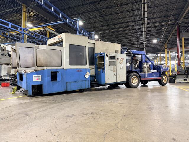 Our 60 80000 lb forklift is pulling out a scrap Mazak CNC from an industrial plant