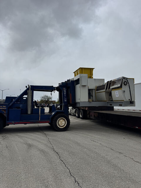 Our heavy forklift loading a granulator on Devon St