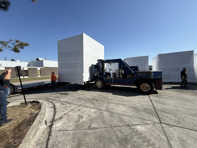 Loading shrink-wrapped machine onto buyer's truck with our forklift on United Lane