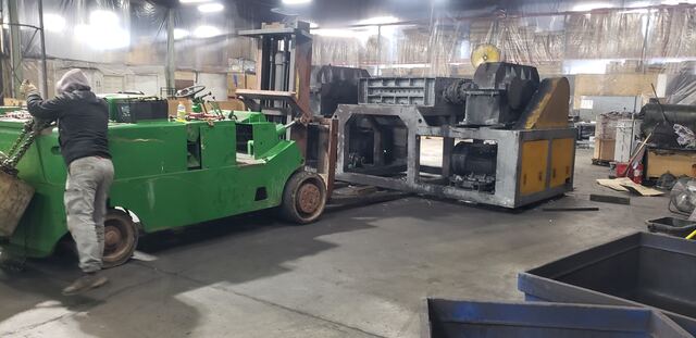 Moving a heavy twin-shaft industrial shredder with our carry-deck forklift