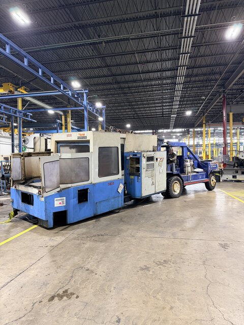 Our 60-80,000 lb forklift pulling a scrap Mazak Mazatech H-630 CNC out across the plant floor