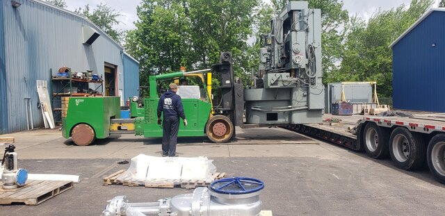 Loading a vertical turret lathe onto our lowboy for removal