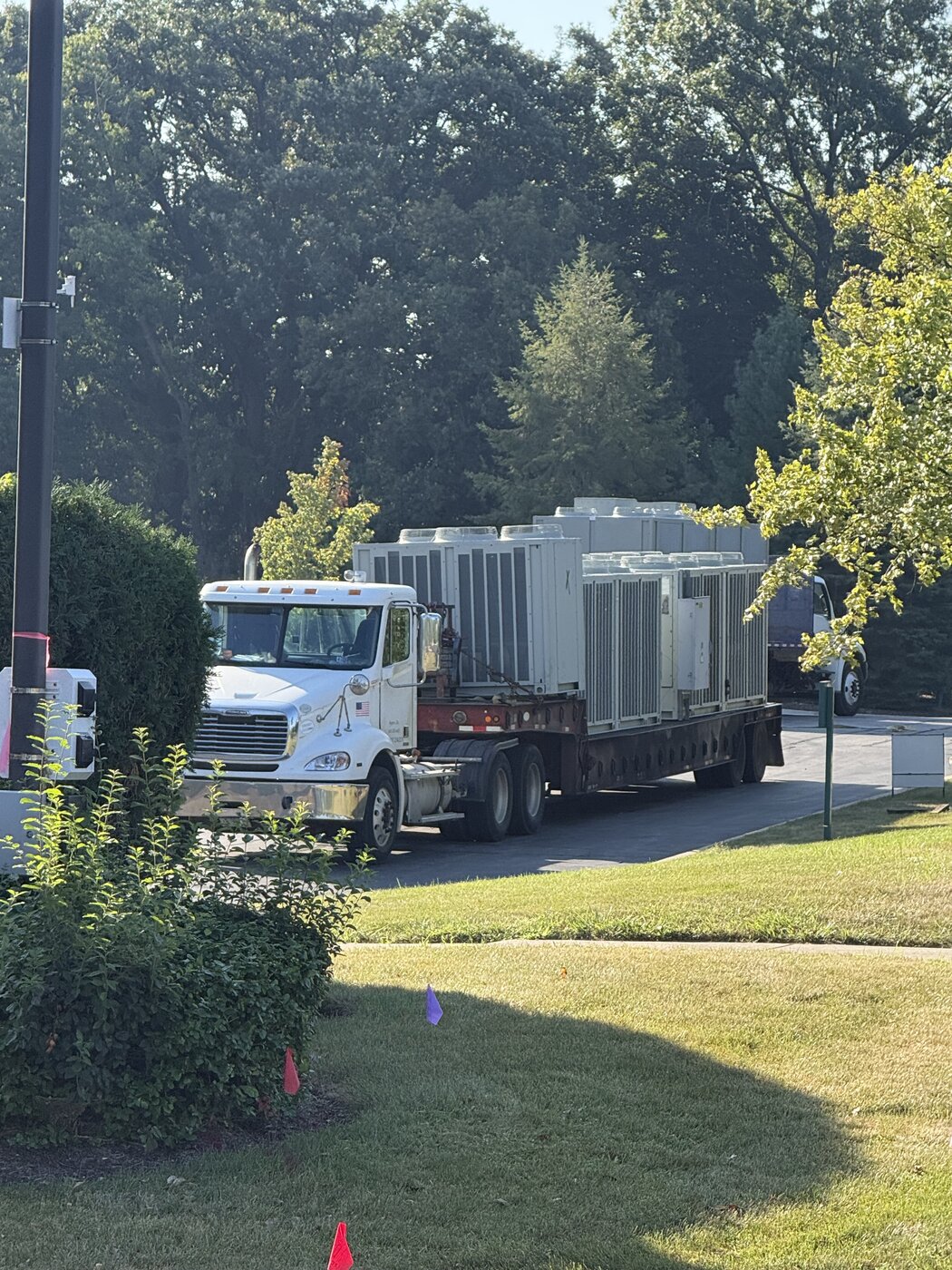 Our truck spotted in the landing zone with the first units already on the trailer, marker flags out and the lot closed to traffic
