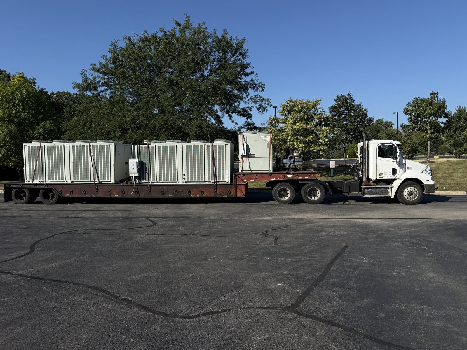 Three rooftop condensing units, 16,000 pounds together, chained and strapped on our lowboy and ready to roll