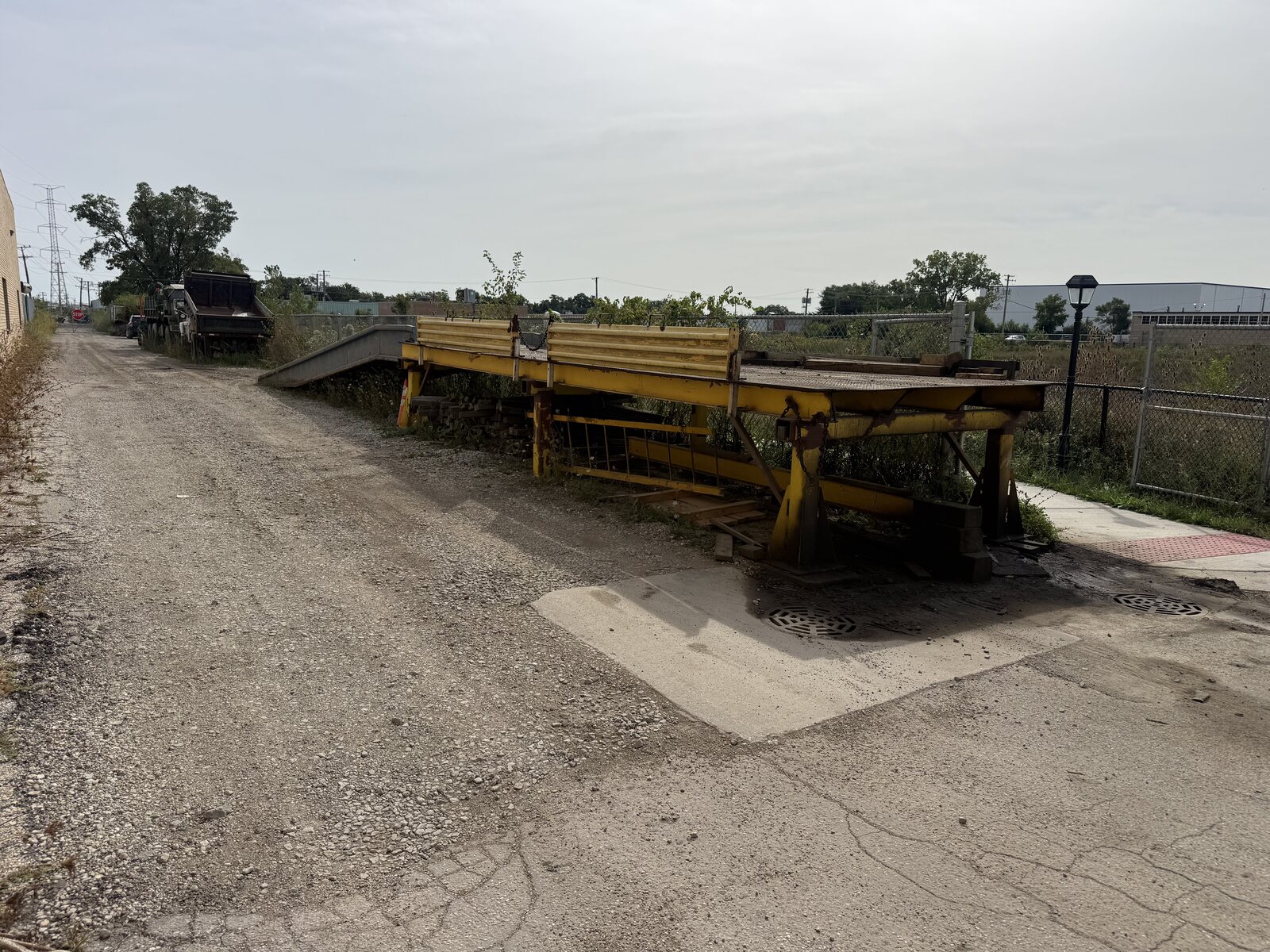 The welded steel deck at the top of our loading ramp, seen from the side, with the yellow rails