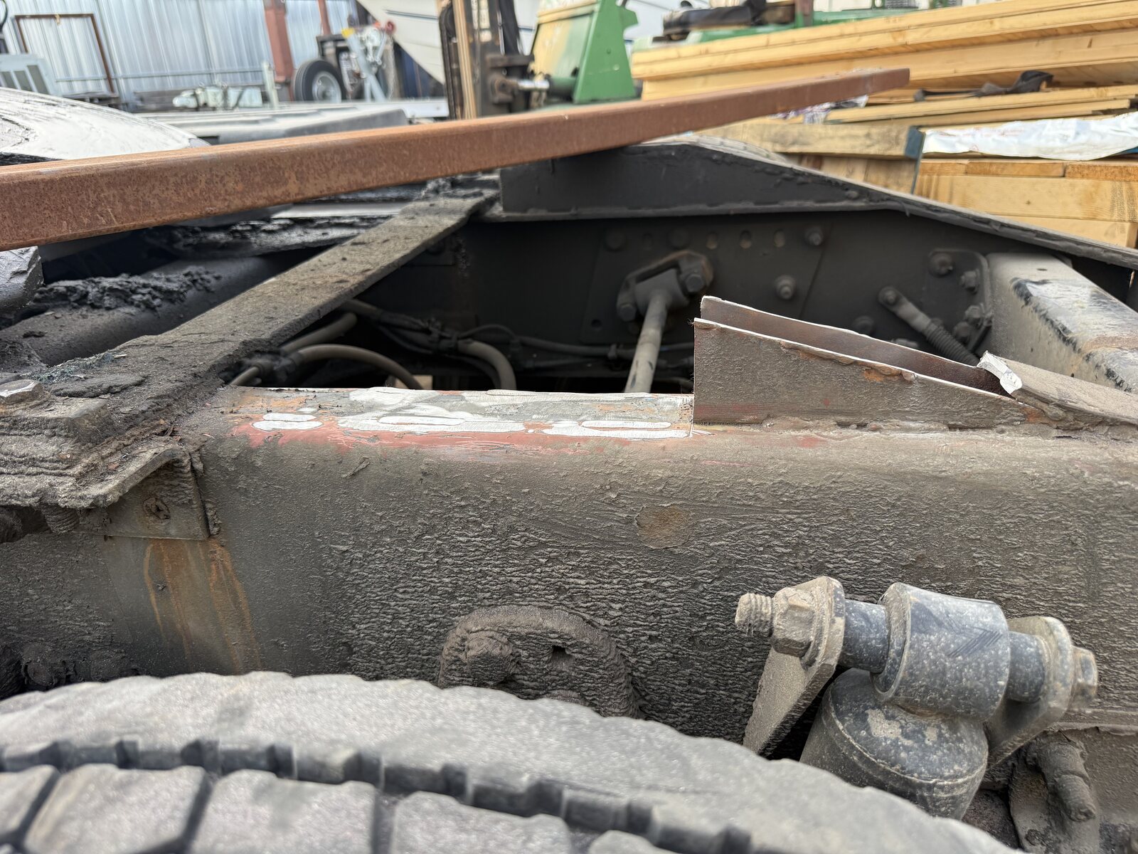 The frame of our semi truck behind the cab where the RGN roller ramp broke, with the damaged support on the frame rail