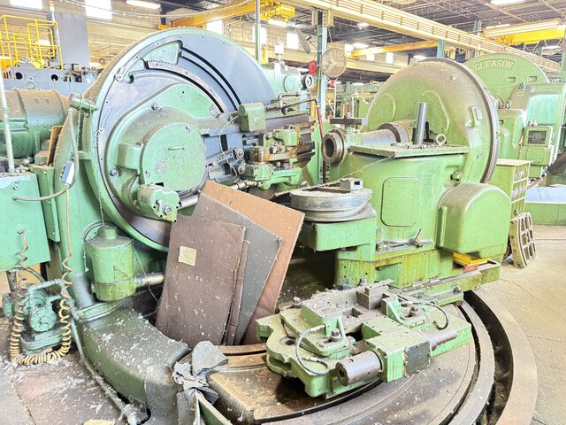 Old green Gleason gear machines on a shop floor