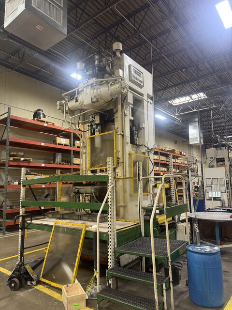 A Verson Hydroform press with a work platform and steps in front of it