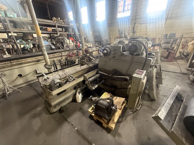 A large lathe, with an electric motor on a pallet in front of it