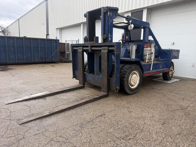 Our blue forklift outside the building, with a roll-off container behind it