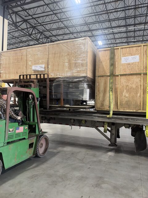 The crate on the trailer deck, next to a crate that is already strapped down