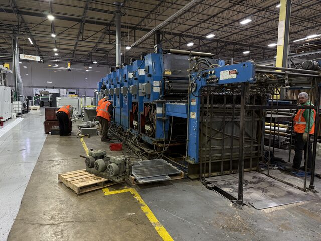 Our crew working along the press line, with parts on pallets in the foreground