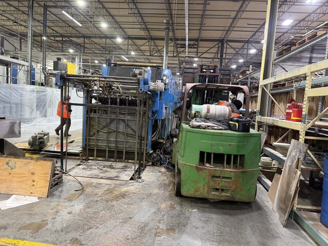 A forklift at the end section of the press