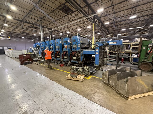 Wide view of the press line, with steel parts on a pallet at the right