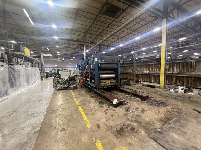 The remaining press units, with steel base rails on the floor in front of them