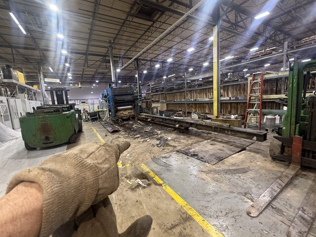 A single press unit and the base rails, with our Towmotor forklift at the left