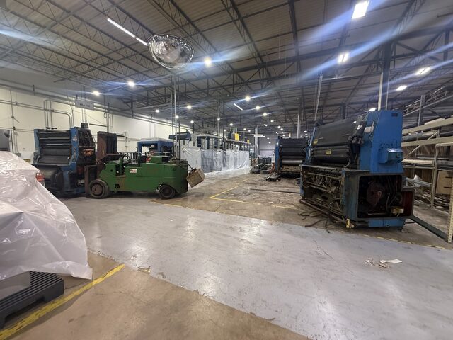Our forklift at a press unit on the left, and another unit standing apart on the right