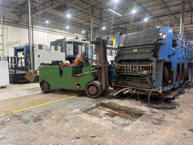 The forklift at the end unit, with the other press units in a row behind it