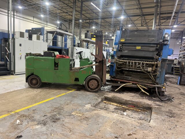 The forks of our Towmotor forklift under the end press unit